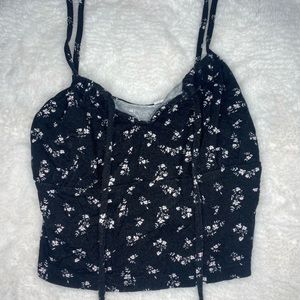 Cropped black floral tank top.